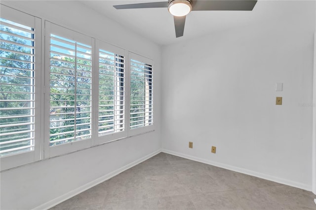 empty room featuring ceiling fan and light tile patterned flooring