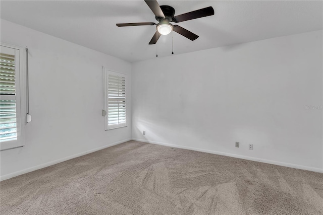 carpeted spare room with ceiling fan and a healthy amount of sunlight