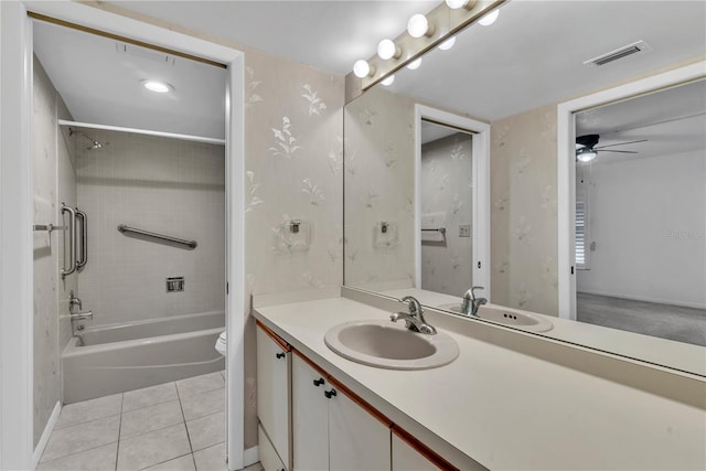 full bathroom with vanity, tile patterned flooring, tiled shower / bath combo, ceiling fan, and toilet