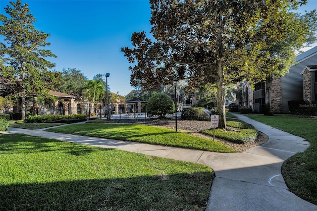 view of property's community with a yard