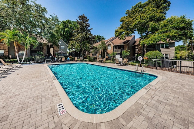 view of swimming pool featuring a patio area