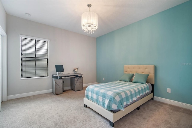 carpeted bedroom with an inviting chandelier