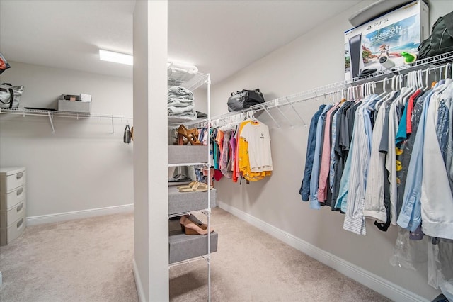 walk in closet featuring light colored carpet