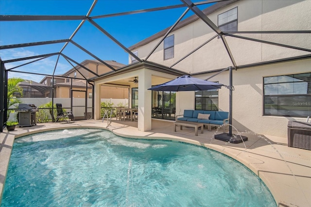 view of pool with glass enclosure, a patio, a grill, an outdoor living space, and ceiling fan