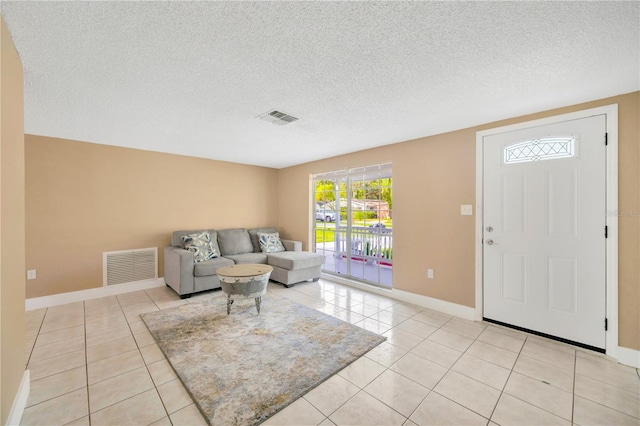 tiled foyer entrance with a textured ceiling