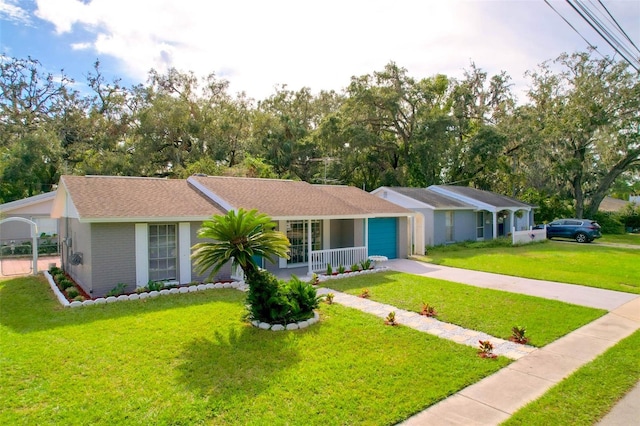 single story home with a garage, a porch, and a front lawn