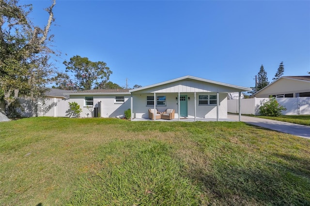 3207 Acacia St, Lutz, FL 33558 - ranch-style house featuring an outdoor hangout area, concrete driveway, and a patio area