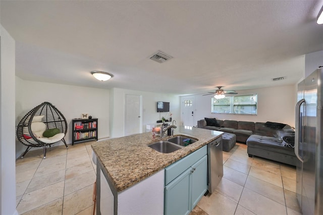 3207 Acacia St, Lutz, FL 33558 - kitchen featuring stainless steel appliances, a sink, open floor plan, and light tile patterned flooring