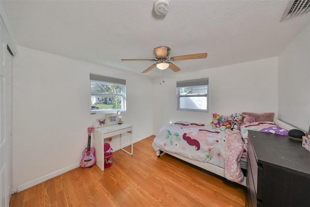 3207 Acacia St, Lutz, FL 33558 - bedroom with light wood finished floors, baseboards, and ceiling fan