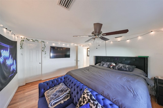 3207 Acacia St, Lutz, FL 33558 - bedroom with wood finished floors, track lighting, baseboards, and ceiling fan