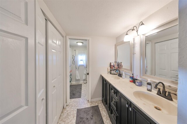 3207 Acacia St, Lutz, FL 33558 - bathroom featuring double vanity, baseboards, and a textured ceiling