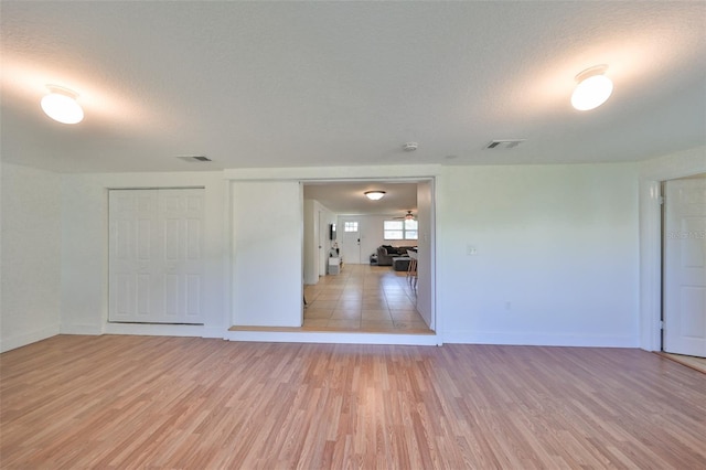 3207 Acacia St, Lutz, FL 33558 - spare room with light wood-style floors, baseboards, and a textured ceiling