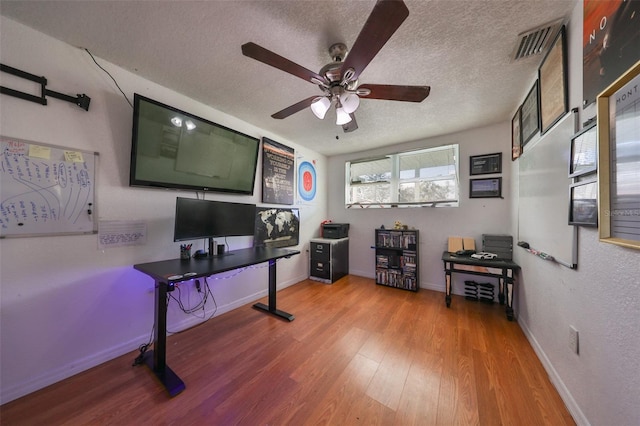 3207 Acacia St, Lutz, FL 33558 - office area featuring a textured ceiling, wood finished floors, ceiling fan, and baseboards