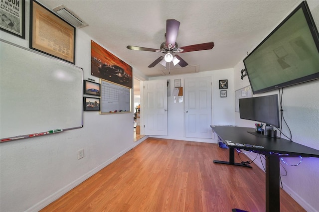 3207 Acacia St, Lutz, FL 33558 - home office featuring wood finished floors, baseboards, a ceiling fan, and a textured ceiling