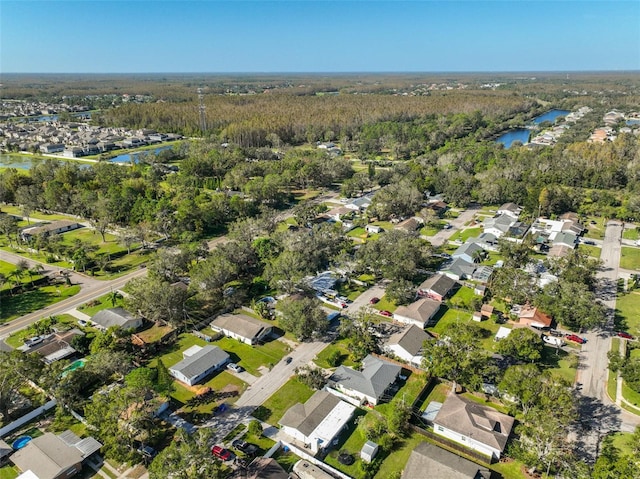 3207 Acacia St, Lutz, FL 33558 - aerial view of property and surrounding area with a heavily wooded area, nearby suburban area, and a nearby body of water