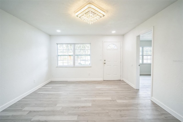 foyer featuring a wealth of natural light and light hardwood / wood-style flooring