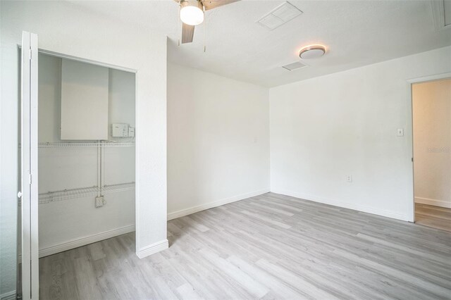 empty room with light hardwood / wood-style floors and ceiling fan