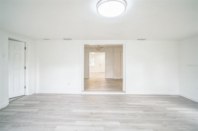 spare room featuring light hardwood / wood-style floors