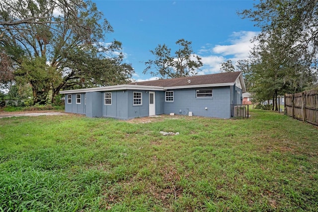 rear view of house with a lawn