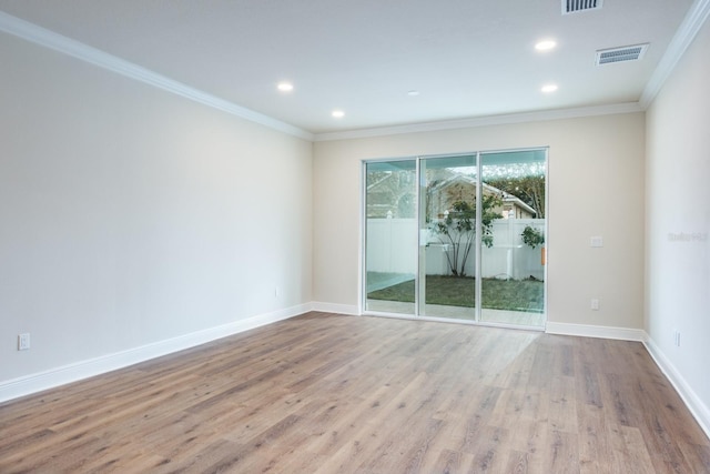 unfurnished room with ornamental molding and light hardwood / wood-style flooring