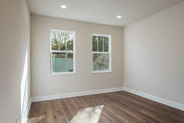 spare room featuring dark hardwood / wood-style flooring