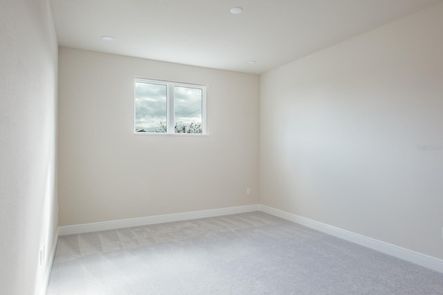 empty room featuring light carpet