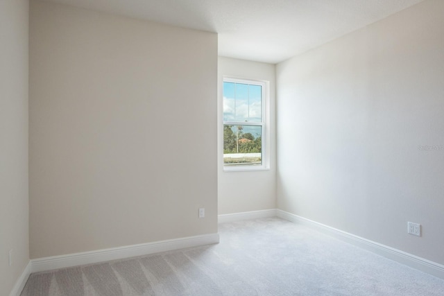 unfurnished room with light carpet