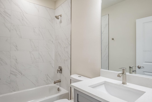 full bathroom featuring toilet, vanity, and tiled shower / bath