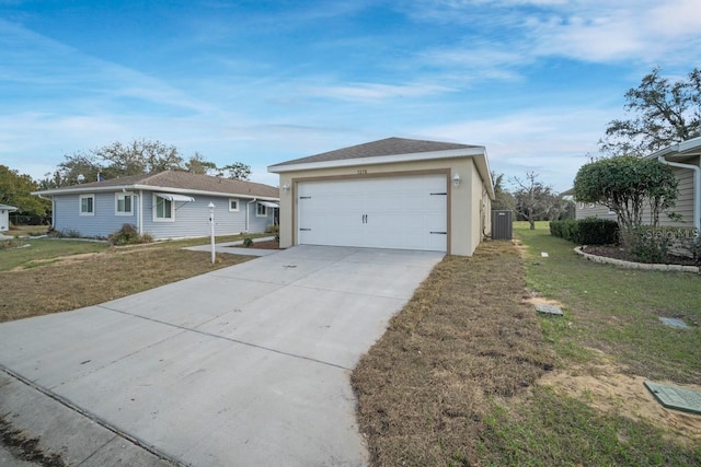 single story home featuring a garage, cooling unit, and a front lawn