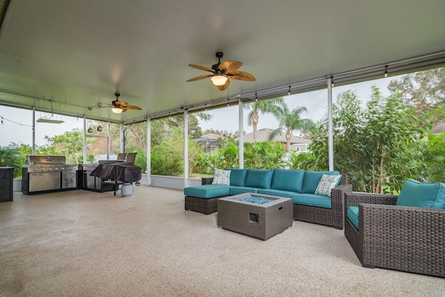 sunroom / solarium featuring a wealth of natural light and ceiling fan