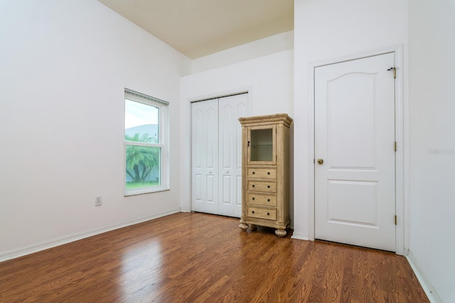 unfurnished bedroom with dark wood-type flooring