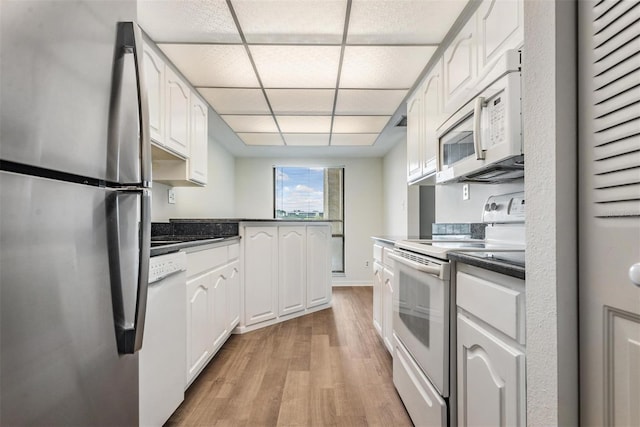 kitchen with white cabinetry, light hardwood / wood-style flooring, a paneled ceiling, and white appliances