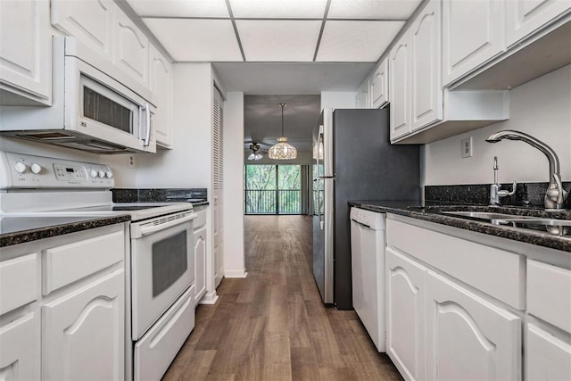 kitchen featuring white cabinetry, white appliances, sink, and dark hardwood / wood-style floors