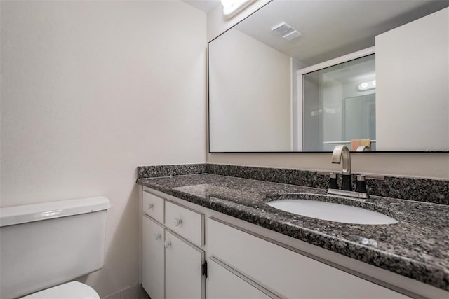 bathroom with toilet and vanity