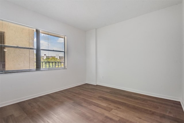 spare room with dark wood-type flooring