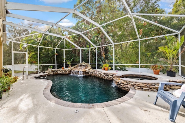 view of pool featuring an in ground hot tub, a patio, a lanai, and pool water feature