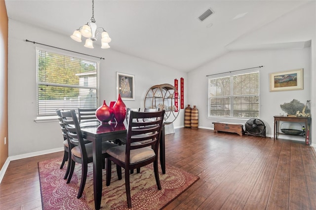 dining space with dark hardwood / wood-style flooring, a notable chandelier, and vaulted ceiling