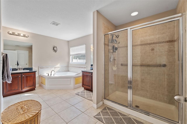 bathroom with vanity, tile patterned floors, separate shower and tub, and a textured ceiling