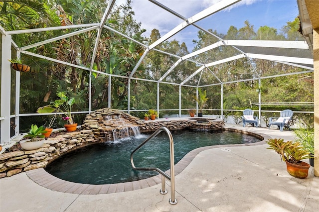 view of swimming pool with a lanai, an in ground hot tub, pool water feature, and a patio area