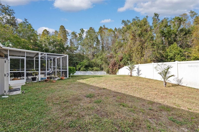 view of yard featuring glass enclosure