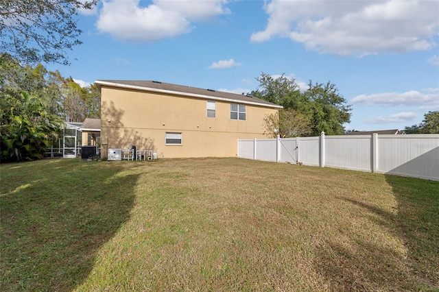 rear view of property with a yard