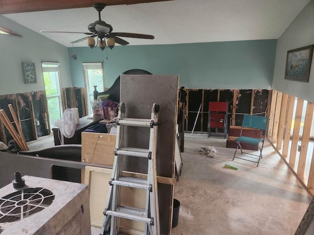 misc room with a textured ceiling, ceiling fan, and vaulted ceiling