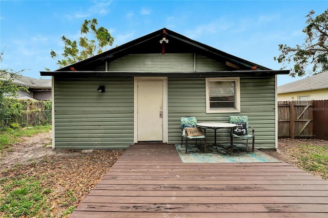 rear view of house with a wooden deck