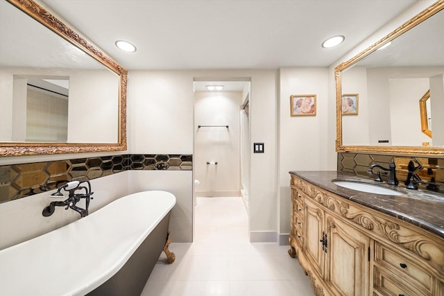 bathroom with tile patterned flooring, a bath, and vanity