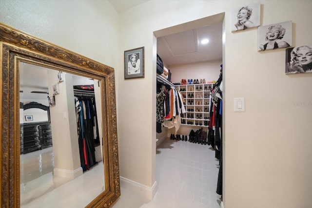 walk in closet with light tile patterned floors