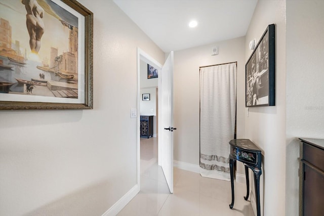 hall with light tile patterned floors