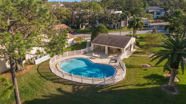 view of pool with a patio area and a yard