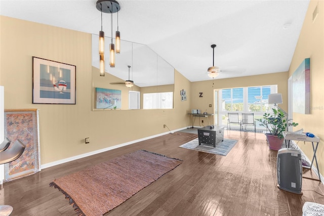 workout room with ceiling fan, dark wood-type flooring, and high vaulted ceiling