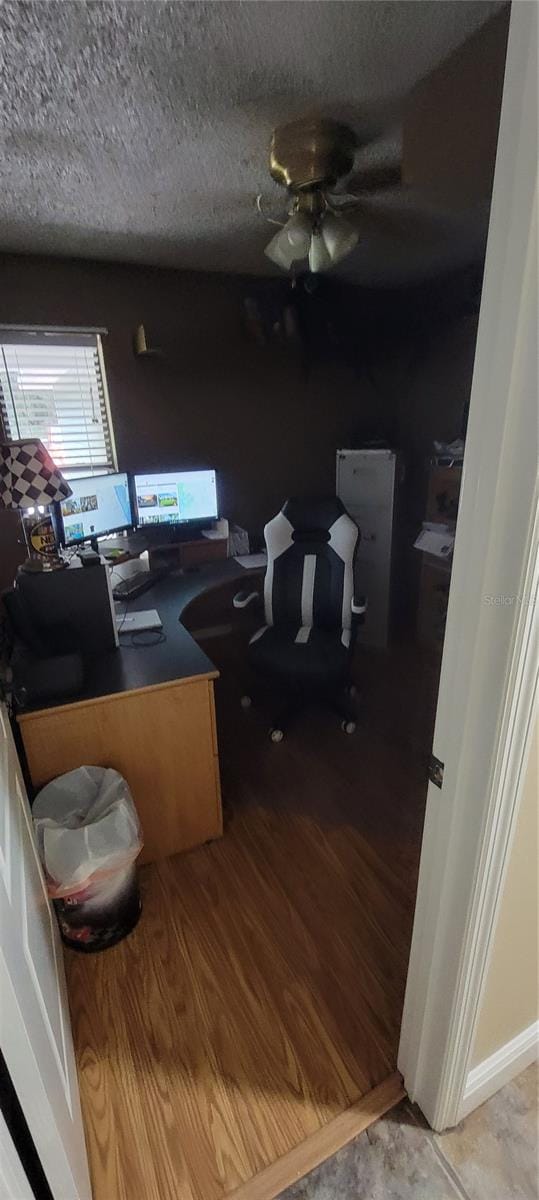 office featuring wood-type flooring, ceiling fan, and a textured ceiling