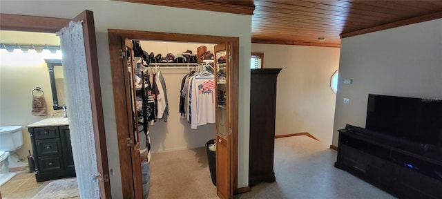 interior space featuring wood ceiling, a closet, and ornamental molding